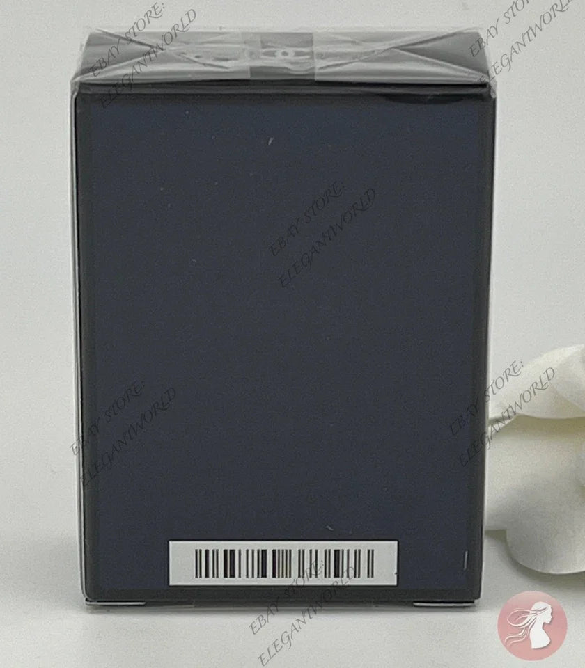 A dark navy blue square product box wrapped in clear plastic, with a barcode label near the bottom, photographed against a light gray background.