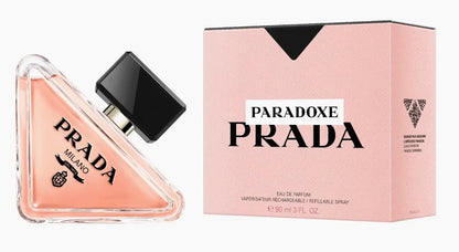Prada Paradoxe Prada Eau de Parfum 90ml bottle next to its signature pink packaging box, on a clean white background.