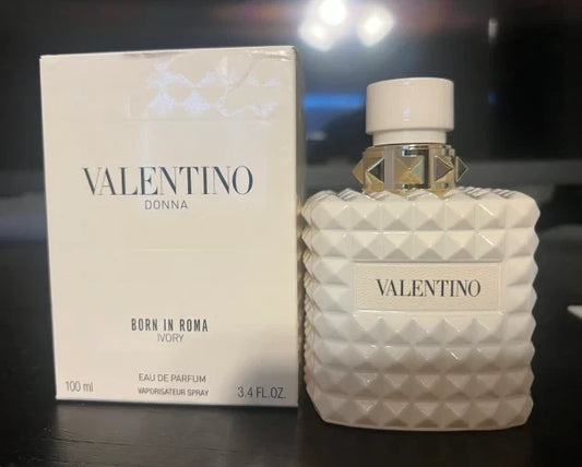 Valentino perfume bottle and packaging on a dark surface