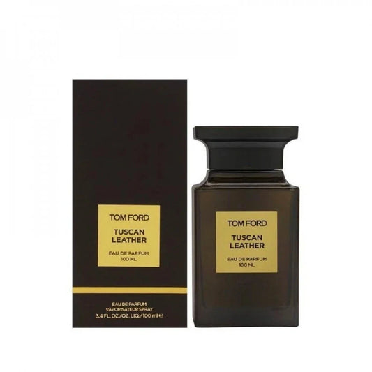 Tom Ford Tuscan Leather Eau de Parfum 100ml bottle next to its black packaging box with gold labels, on a plain white background.